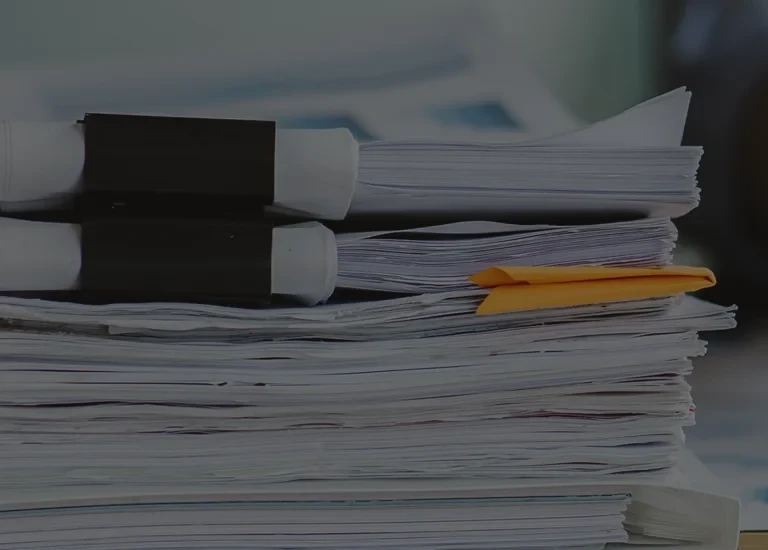 a stack of papers sitting on top of a desk